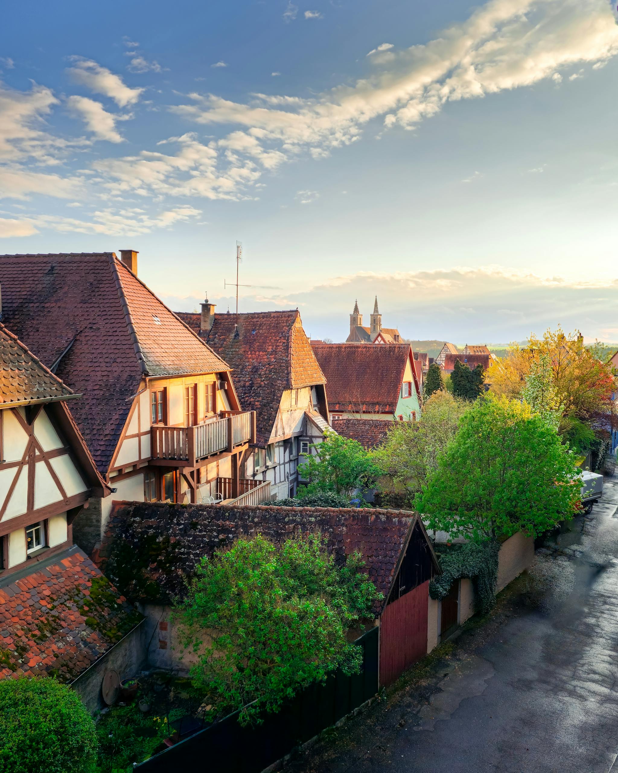 A picturesque view of a traditional Alsatian village with half-timbered houses under a beautiful sunset sky.